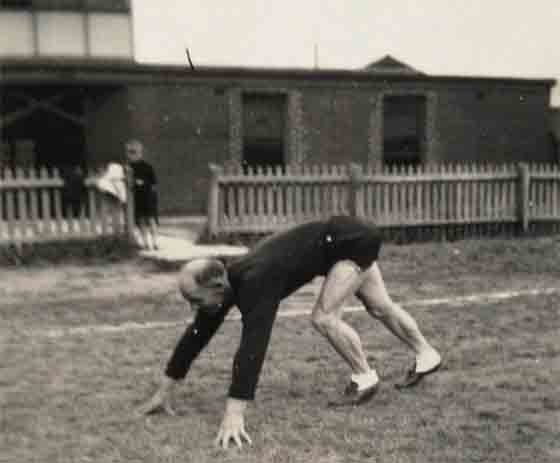 Percy Allan May training at North Port Oval with son John watching on from the fence.